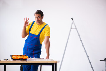 Young male carpenter working indoors
