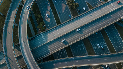 Obraz premium Top up aerial drone view of elevated road and traffic junctions in Chinese metropolis city Chengdu during sunny day. Modern construction design of traffic ways to avoid traffic jams. Few vehicles.