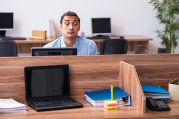 Young male employee in industrial espionage concept