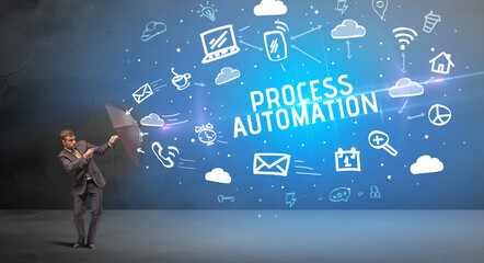 Businessman defending with umbrella from PROCESS AUTOMATION inscription, modern technology concept