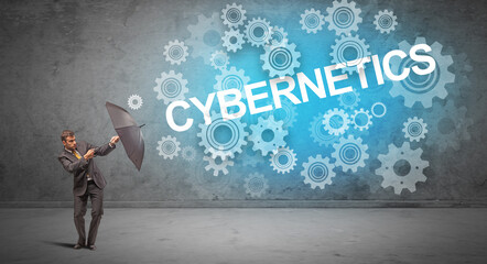 Obraz premium Businessman defending with umbrella from CYBERNETICS inscription, technology concept