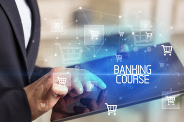 Young person makes a purchase through online shopping application with BANKING COURSE inscription