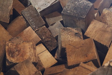 Firewood pile with a cross-section of wooden blocks.