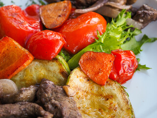Beefsteak with tomato and herbs on a red background
