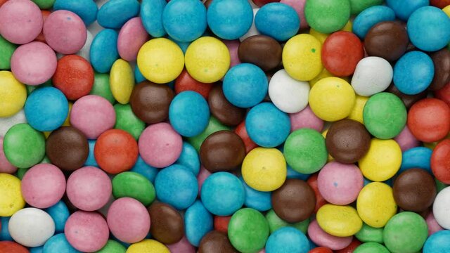 Chocolate dragees - background. Multicolored dragees, top view.