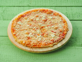 pizza on a wooden green background. Italian kitchen