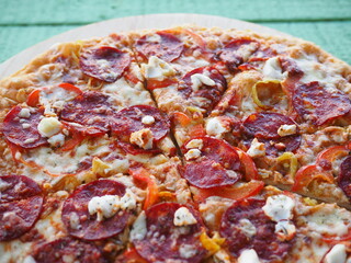 pizza on a wooden green background. Italian kitchen