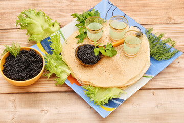 Pancakes with black caviar