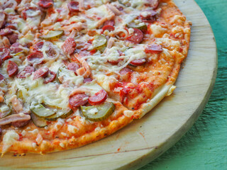 pizza on a wooden green background. Italian kitchen
