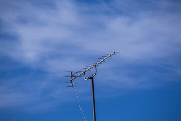 Antenna isolated against a blue skyline image for background use with copy space