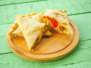 pie with tomatoes on a green wooden background