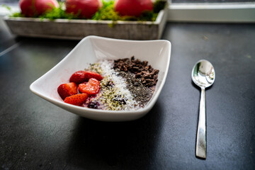 An organic, plant-based, gluten-free oatmeal bowl made from ingredients such as: steel-cut oats, berries, coconut, cacao nibs, oatmilk, hemp hearts, chia seeds