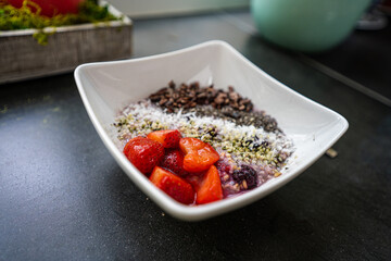 An organic, plant-based, gluten-free oatmeal bowl made from ingredients such as: steel-cut oats, berries, coconut, cacao nibs, oatmilk, hemp hearts, chia seeds