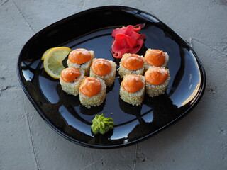 Japanese kitchen. Sushi and rolls on gray concrete background