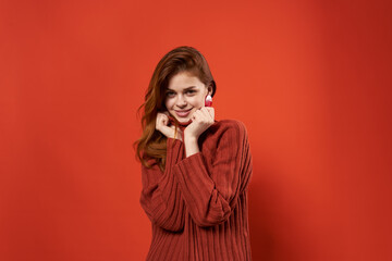 pretty woman in red sweater decoration fashion hairstyle glamor red background