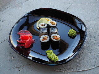 Japanese kitchen. Sushi and rolls on gray concrete background