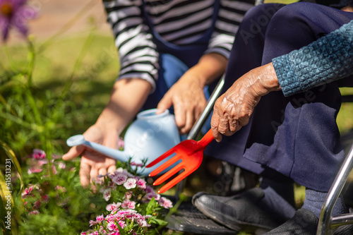 Mother's Day , Senior woman and daughter relax with gardening in backyard