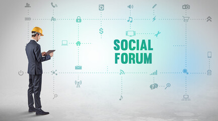 Engineer working on a new social media platform with SOCIAL FORUM inscription concept
