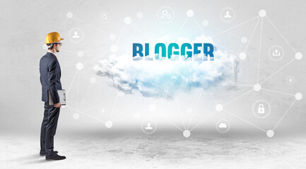 Engineer working on a social media concept with BLOGGER inscription