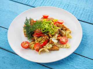 Chicken salad on blue wooden background