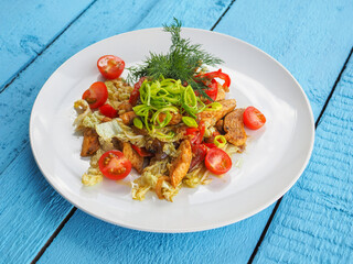 Chicken salad on blue wooden background