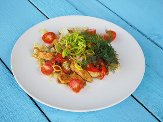 Chicken salad on blue wooden background