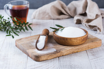 Natural sweetener in a wooden spoon. Sugar substitute. Erythritol