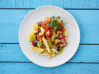 Chicken salad on blue wooden background