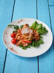 Chicken salad on blue wooden background