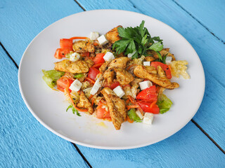 Chicken salad on blue wooden background