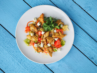 Chicken salad on blue wooden background