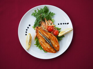 Baked salmon in foil on a red background