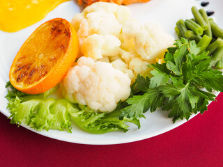 Baked salmon in foil on a red background