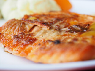 Baked salmon in foil on a red background