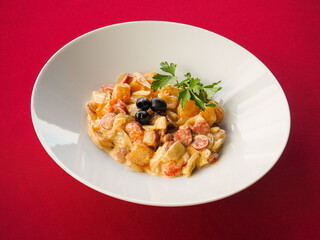 Sausage salad on red background