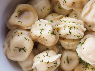 Fried dumplings with dill in a plate