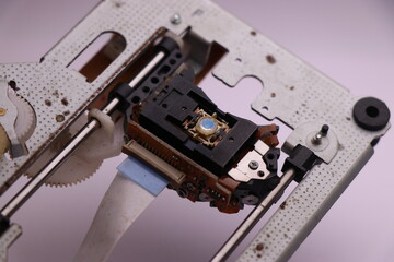 DVD Drive with close-up of laser part. Inside part of CD burning and cd reading device