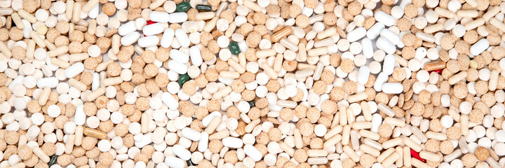 Background made of different pills. Concept of illness and treatment. Medicine and healthcare.