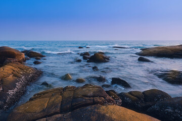 Fototapeta na wymiar Rocks on the beach in the evening