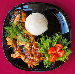 Beefsteak with tomato and herbs on a red background