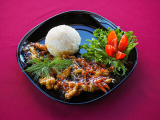 Beefsteak with tomato and herbs on a red background