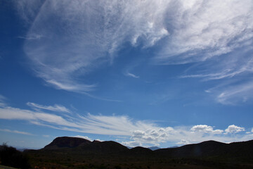 Late afternoon silhouetted Karoo hills with blue sky and cloud patterns