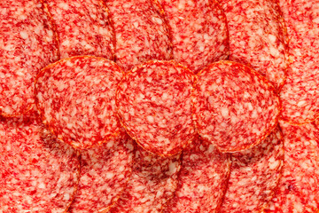 Slices of ham sausage as a natural background . Tasty salami slices ias a natural background . Smoked Sausage slices, as a natural background
