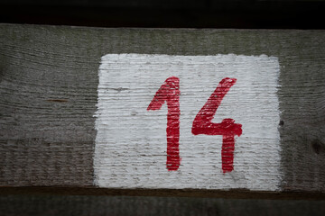 Closeup shot of number 14 on a wooden surface - obrazy, fototapety, plakaty