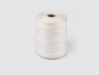 Roll of thin string on a white background
