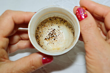close-up - a cup with patterns of coffee grounds in the hands of a fortuneteller