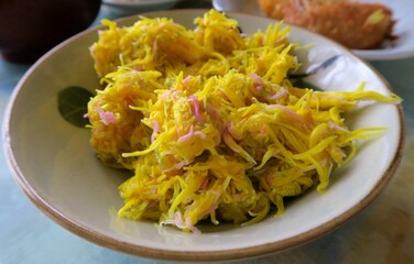 Cooked yellow chrysanthemum called Mottenohoka in a bowl.