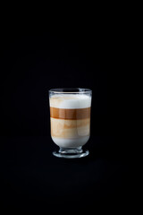 Coffee with milk on dark background. Close up. Copy space.