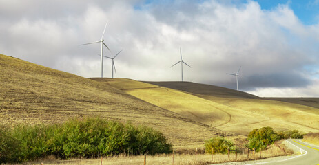 Wind farm in california, on the hills, summer, bright sunny weather with clouds. Concept, pure...