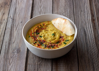 Hummus with seasonings and pita. Healthy eating. Vegetarian food. Diet.